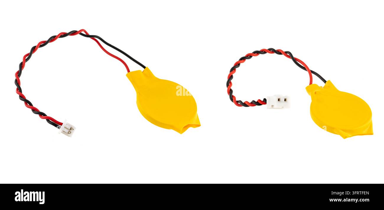 Yellow CMOS backup battery with twisted wires and pin connector Stock Photo