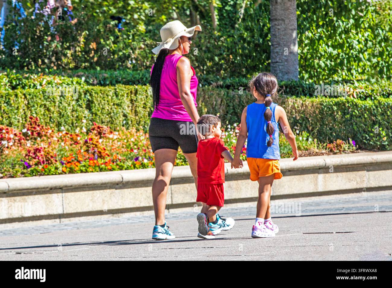 Mathor 2 A mother with her daughter and son walking in a park in Paris, August ...