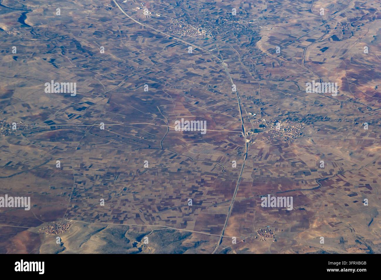 Aerial view of patchwork farmland and small rural villages connected by ...