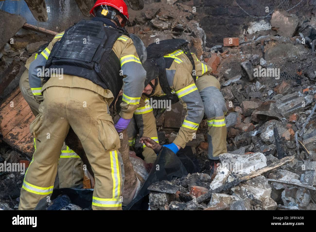 File Rescue Software Rescue workers recover the body of a resident killed in an Russian air ...