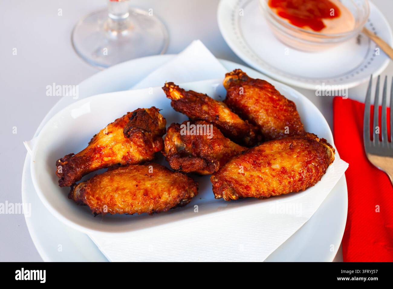 Appetizing baked chicken wings in a plate closeup Stock Photo - Alamy