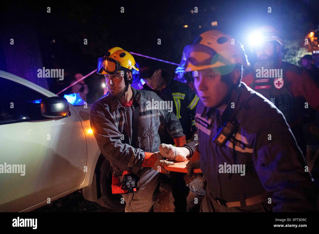 File Rescue Software Rescue workers evacuate an injured woman from a multi-story residential ...
