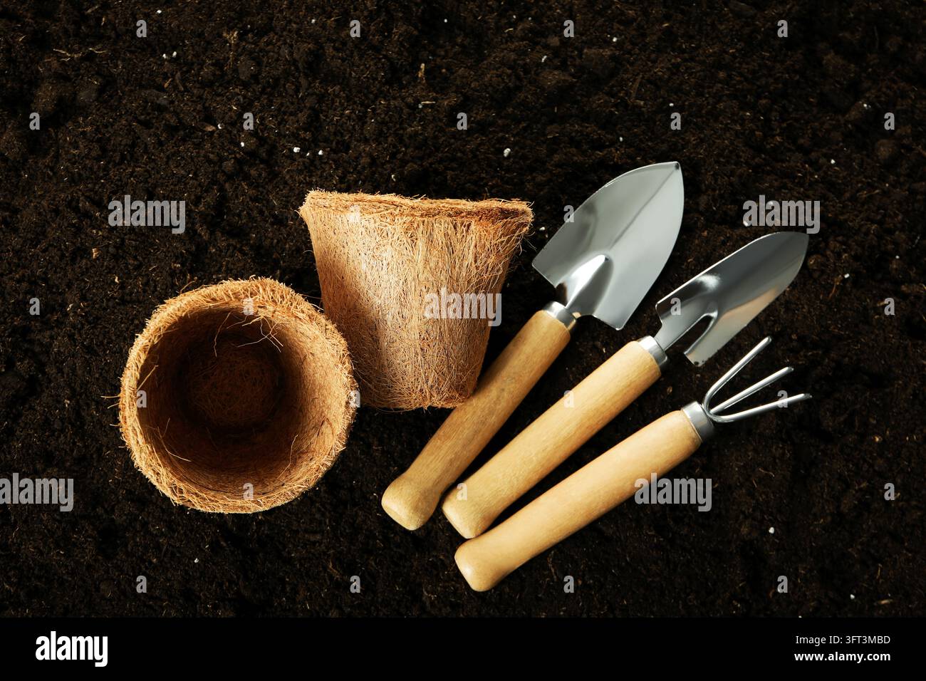 Gardening tools on soil background, top view Stock Photo - Alamy