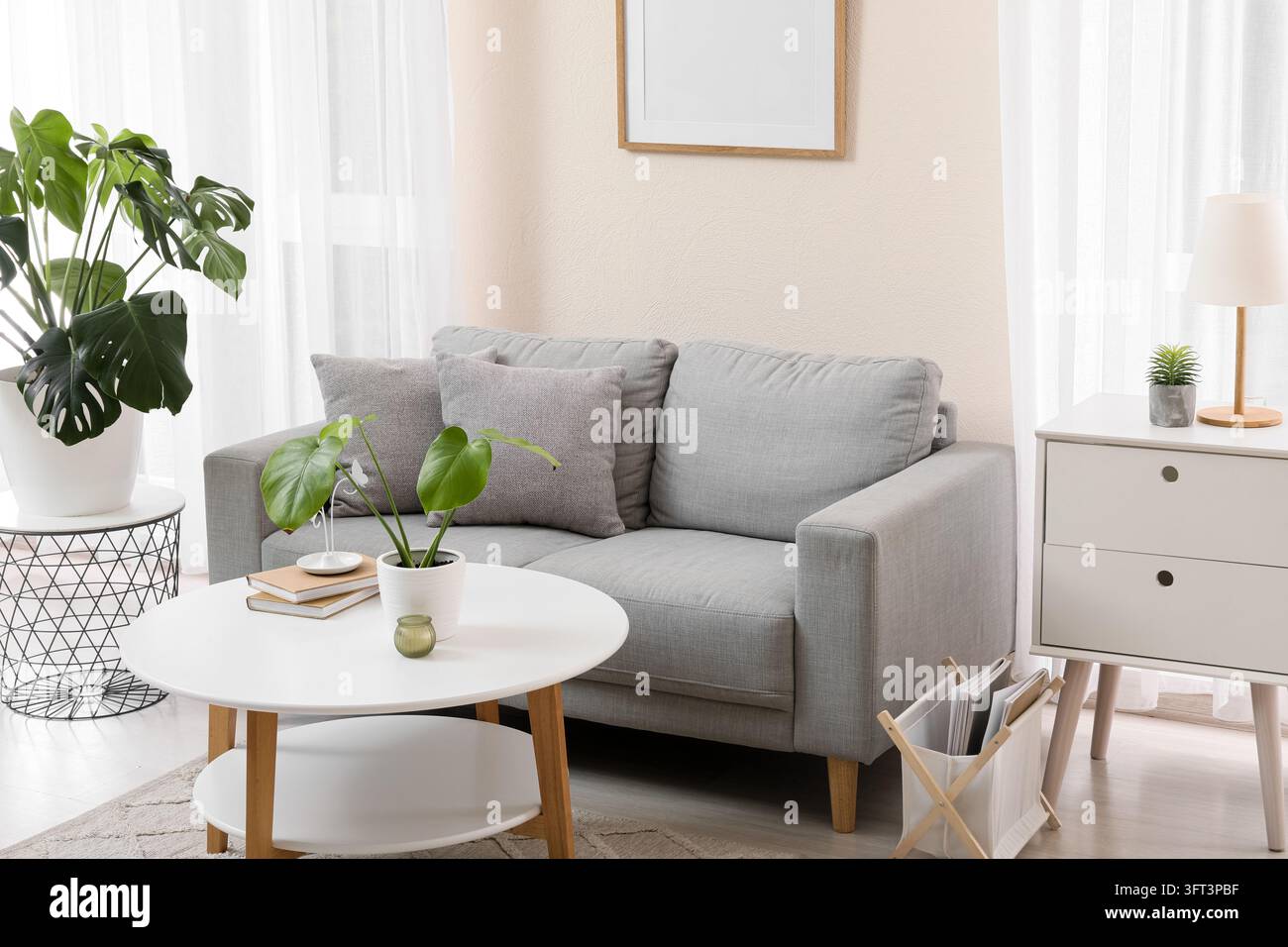 Interior design and home comfort, modern living room with grey sofa and ...