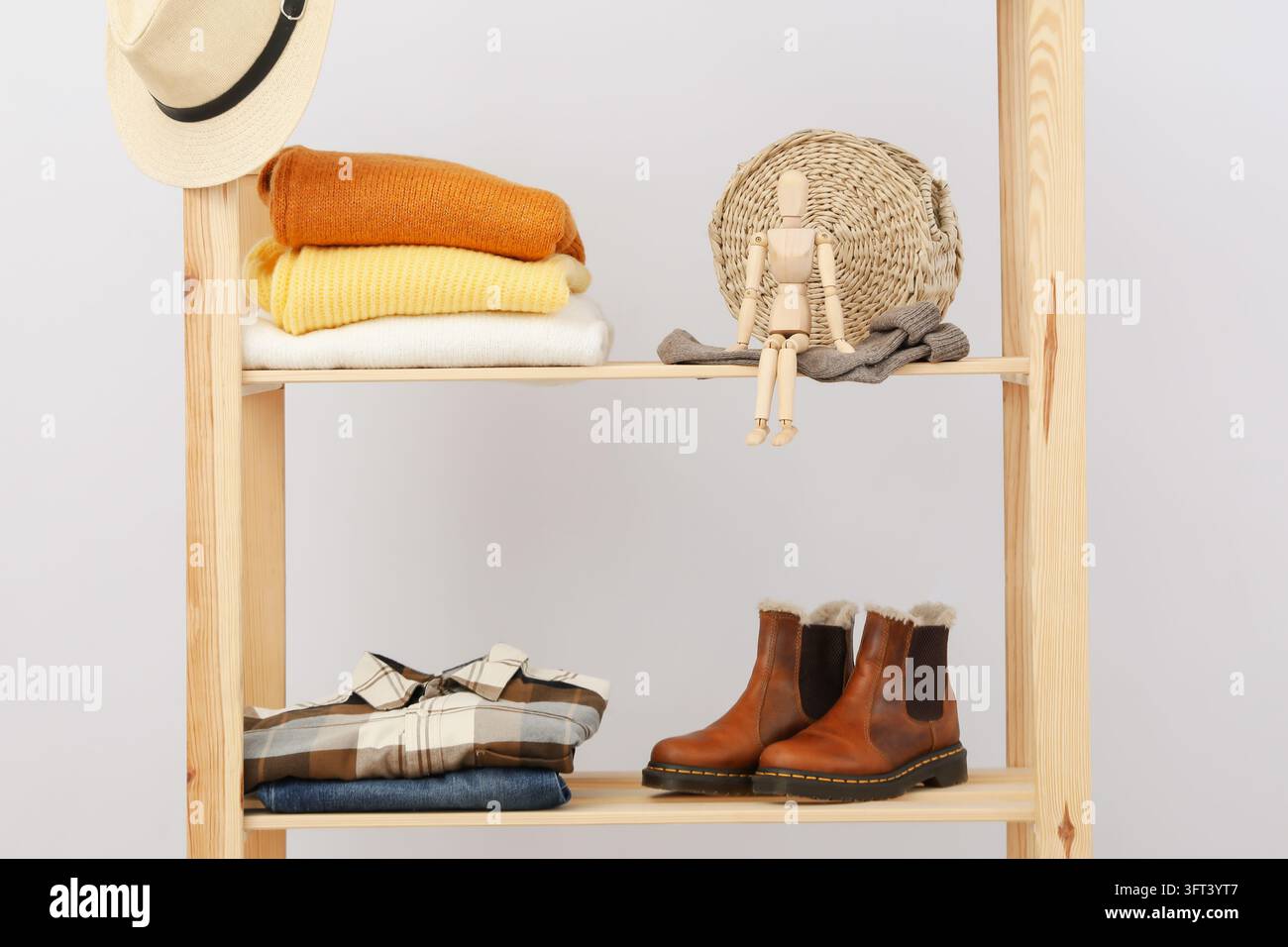 Wooden shelving with clothes, autumn season clothes Stock Photo - Alamy