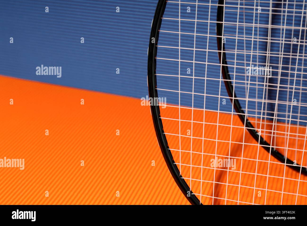 Badminton rackets on orange and blue textured backgrounds Stock Photo ...