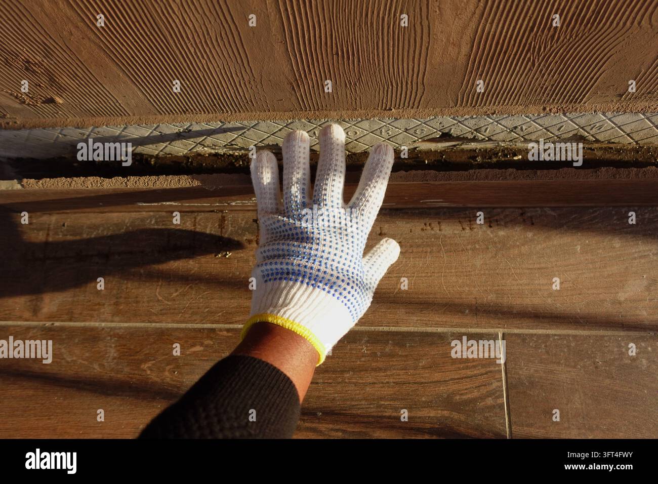 Worker Hand With Glove Inspecting Wooden Floor Seam During Home ...