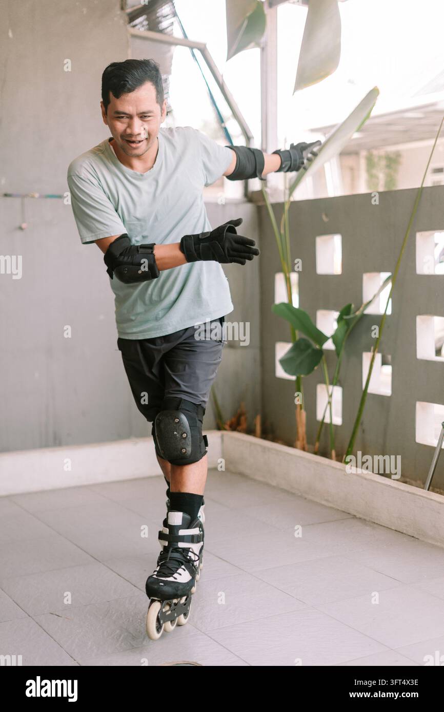 A man practices inline skating on an outdoor patio while wearing ...
