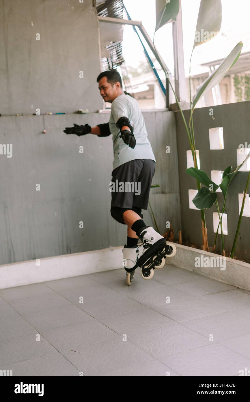 An individual enjoys inline skating on a tiled outdoor patio wearing ...