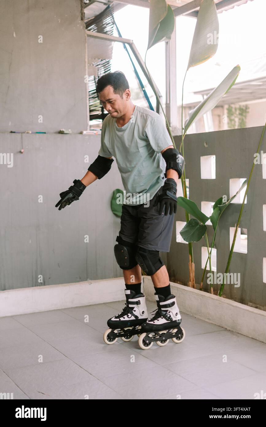 An adult practicing inline skating wearing protective gear on an ...