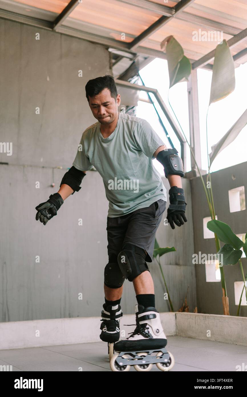 An individual practicing inline skating wearing protective pads and a ...
