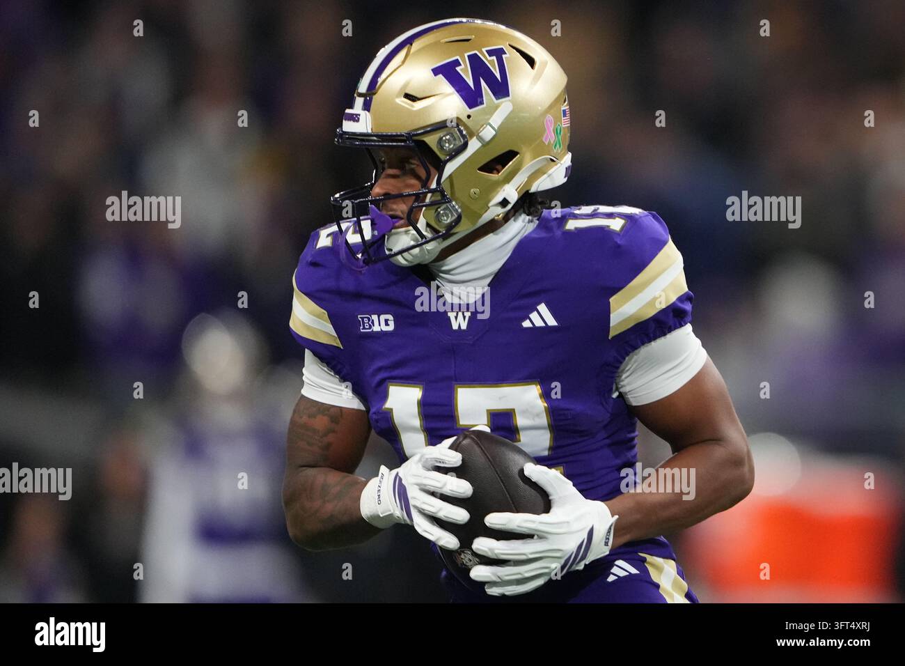 Trez Washington wide receiver Trez Davis moves the ball against Iowa during ...