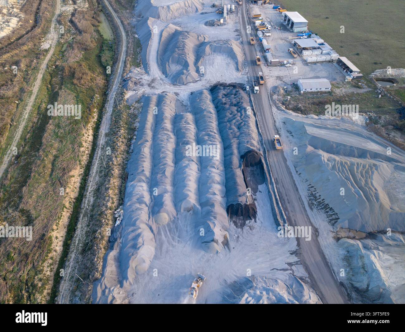 Aerial view of a large industrial quarry site with piles of gravel and ...