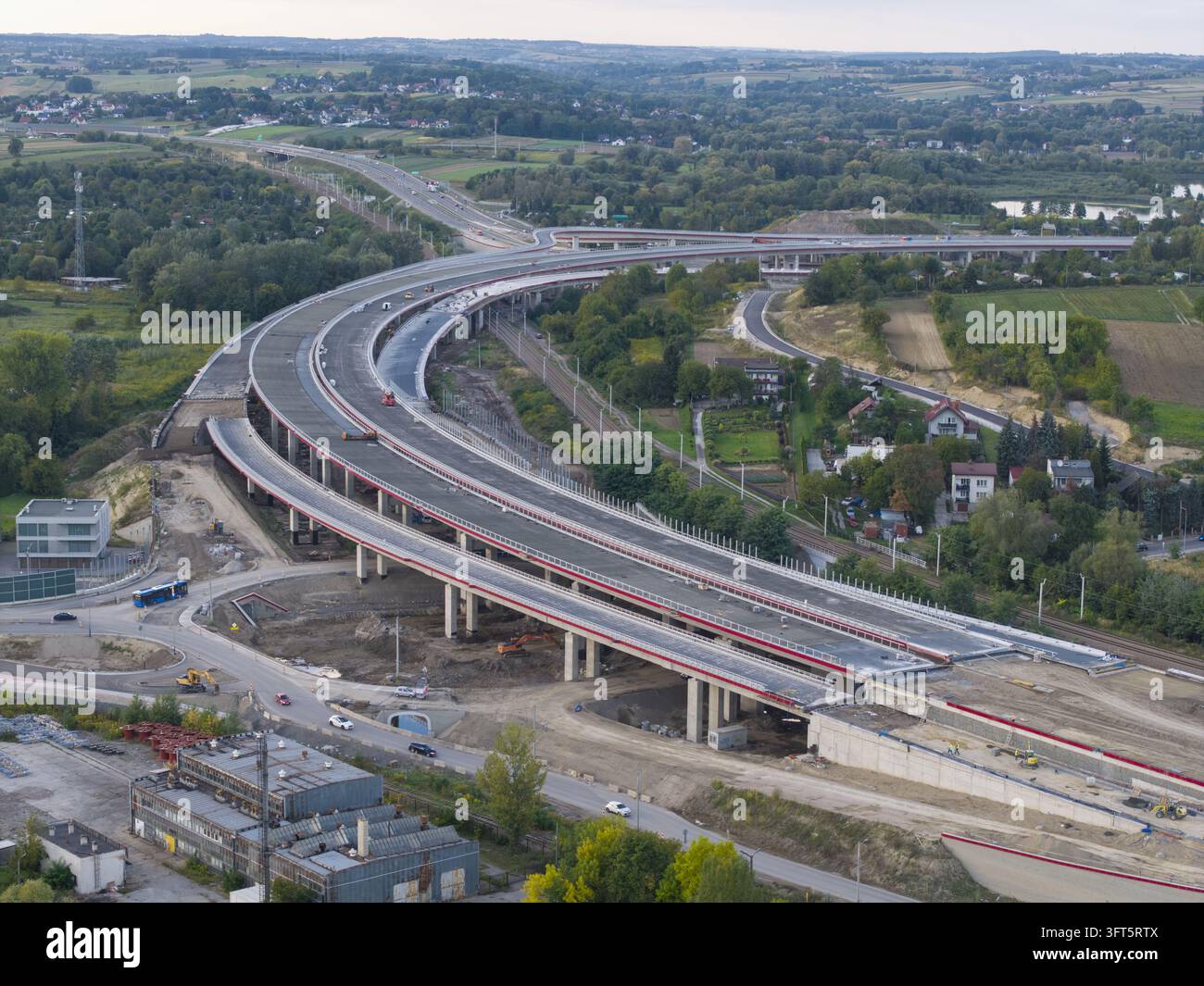 Aerial view of a modern highway interchange under construction with ...