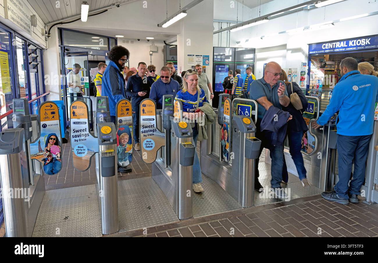 Passengers passing Northern ticket barriers at Warrington Central railway station. Stock Photo