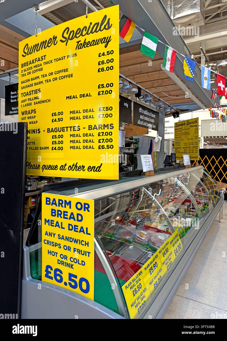 Warrington Market hot-food stall advertises traditional barm and bread-roll meal deals. Stock Photo