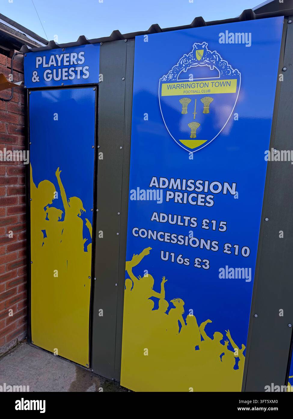 Warrington Town FC players and guests admission-price notice on a blue entrance door at Cantilever Park. Stock Photo