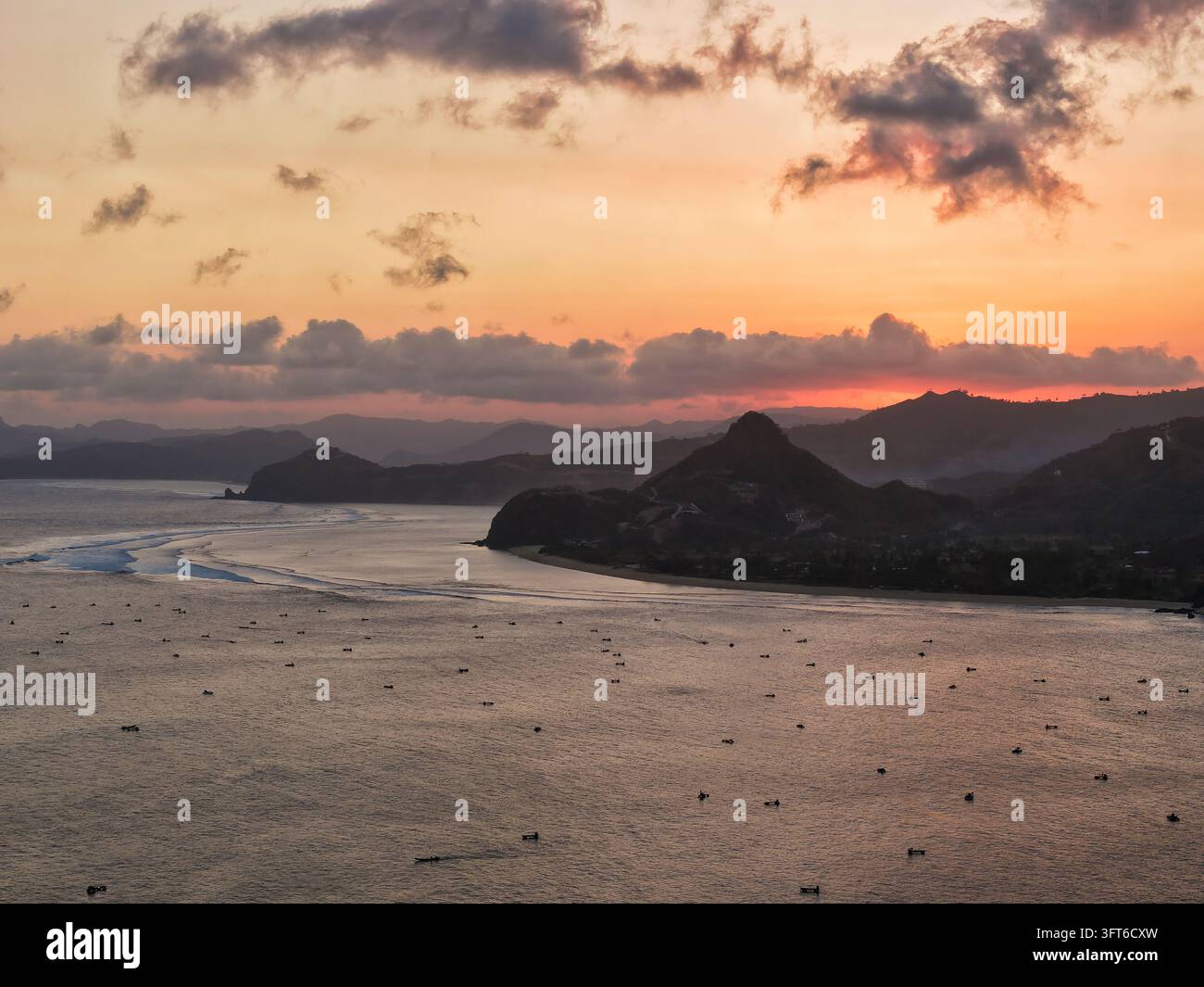 Aerial view of Selong Belanak Beach at sunset, with fishing boats on ...