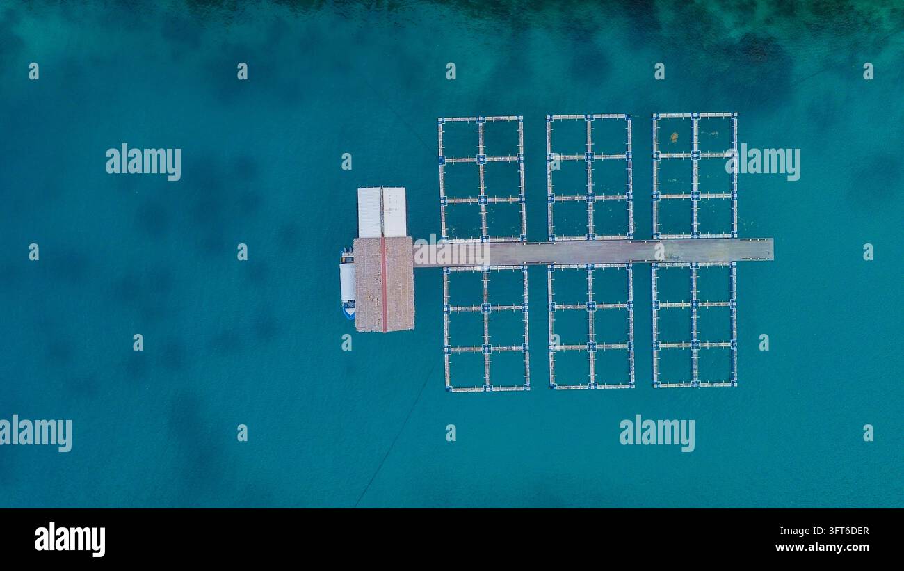 Floting Farm Aerial view of a fish farm structure with floating cages and a small ...