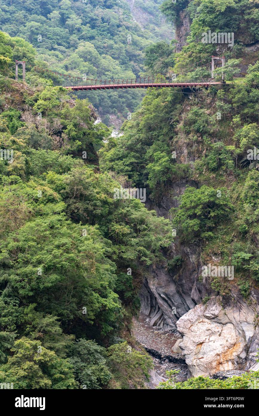 View of the suspension bridge spanning the lush green gorge of Taroko ...