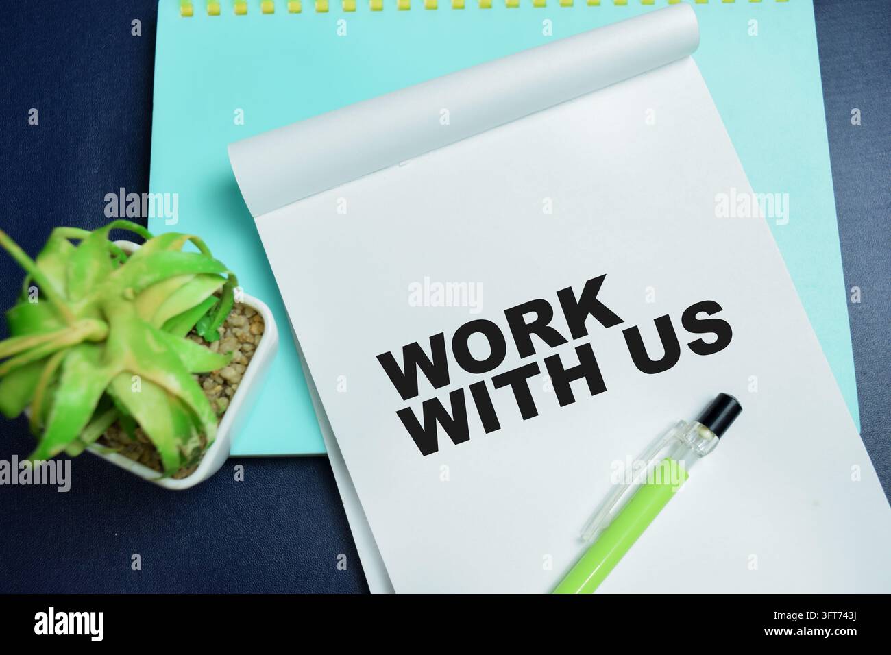 Concept of work with us write on book isolated on table. Stock Photo