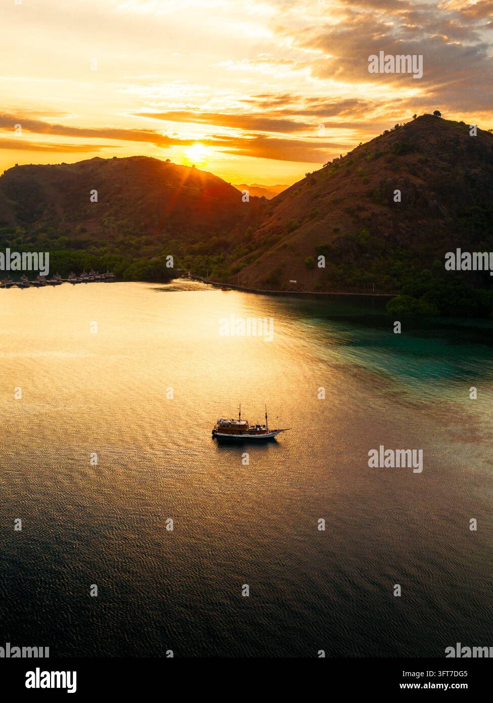 Aerial view of Manjarite Beach at sunset with a traditional boat ...