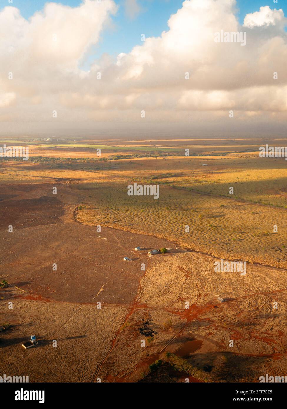 Aerial view of the arid landscape with sparse vegetation, small rural ...