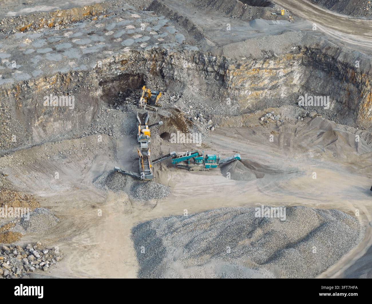 Aerial view of a cement quarry featuring heavy machinery, conveyor ...