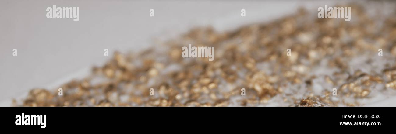 Abstract blurred perspective view of golden foil particles on white plaster surface for luxury decorative backdrop stock photo layout. Stock Photo