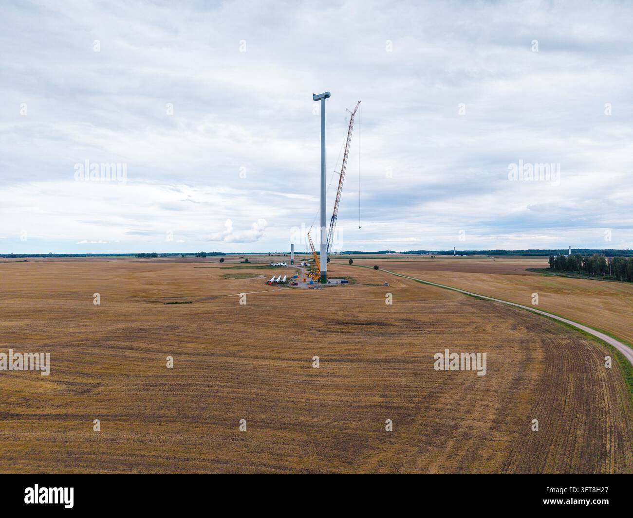 Aerial view of a wind farm under construction with a tall turbine tower ...