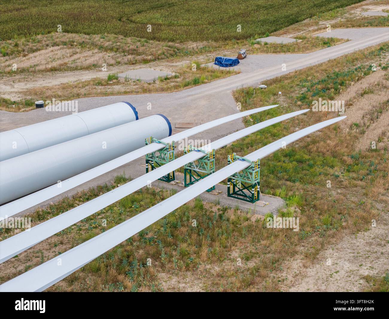 Aerial view of wind turbine blades and tower sections staged on the ...