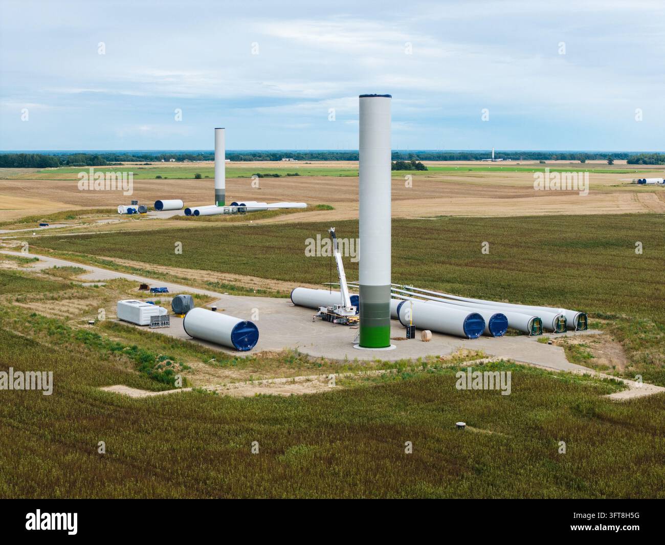 Aerial view of wind farm construction site featuring tall turbine ...