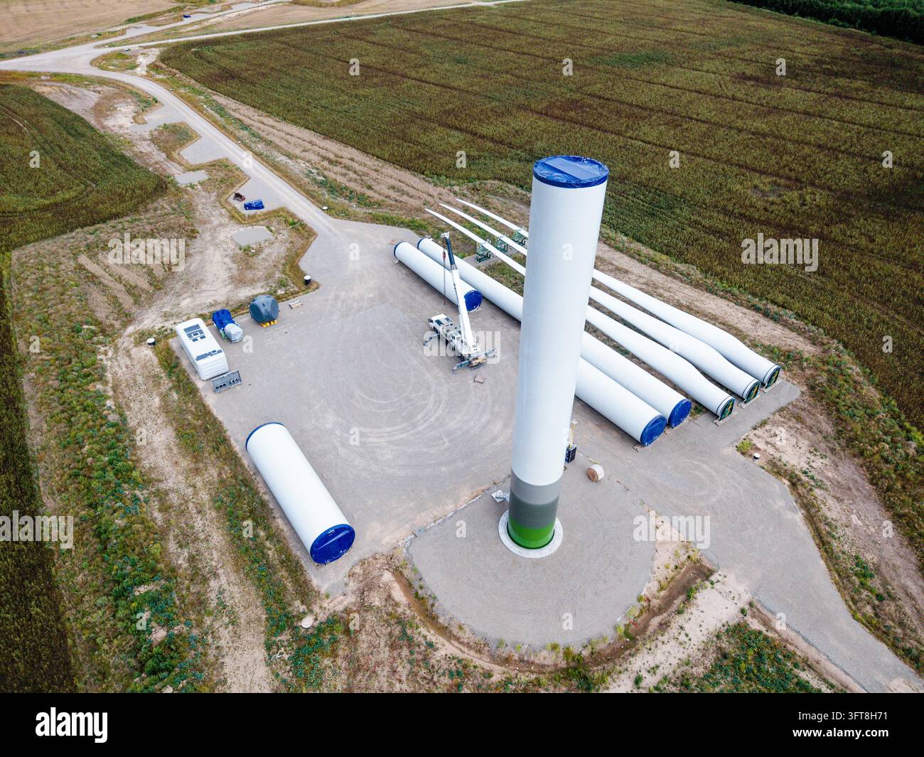 Aerial view of wind farm construction site featuring a tall turbine ...