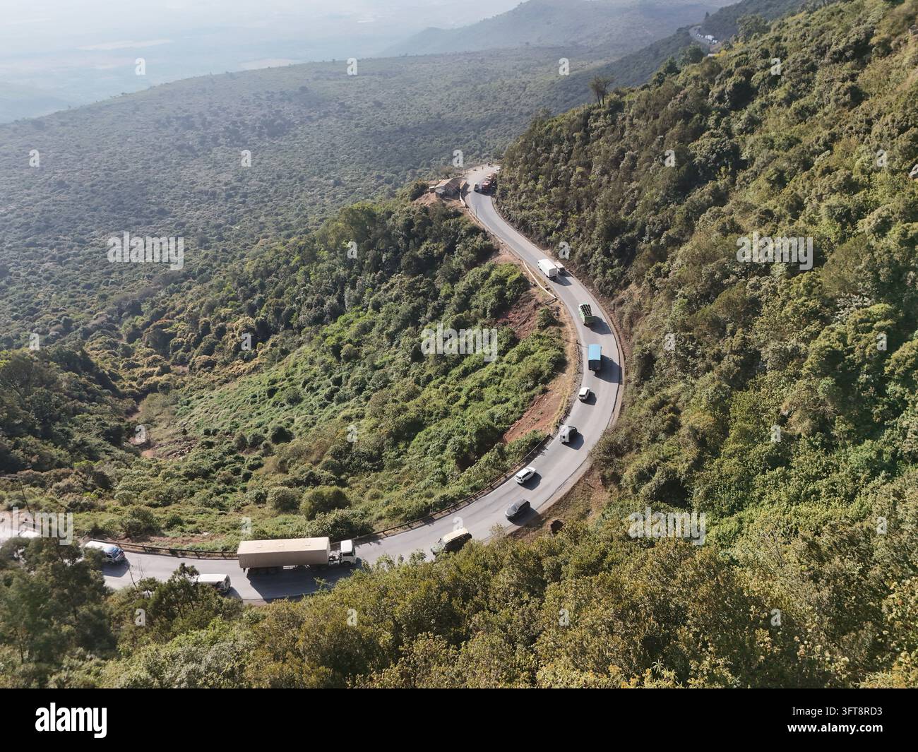 Aerial view of Mai Mahiu Road winding through the lush green hills and ...