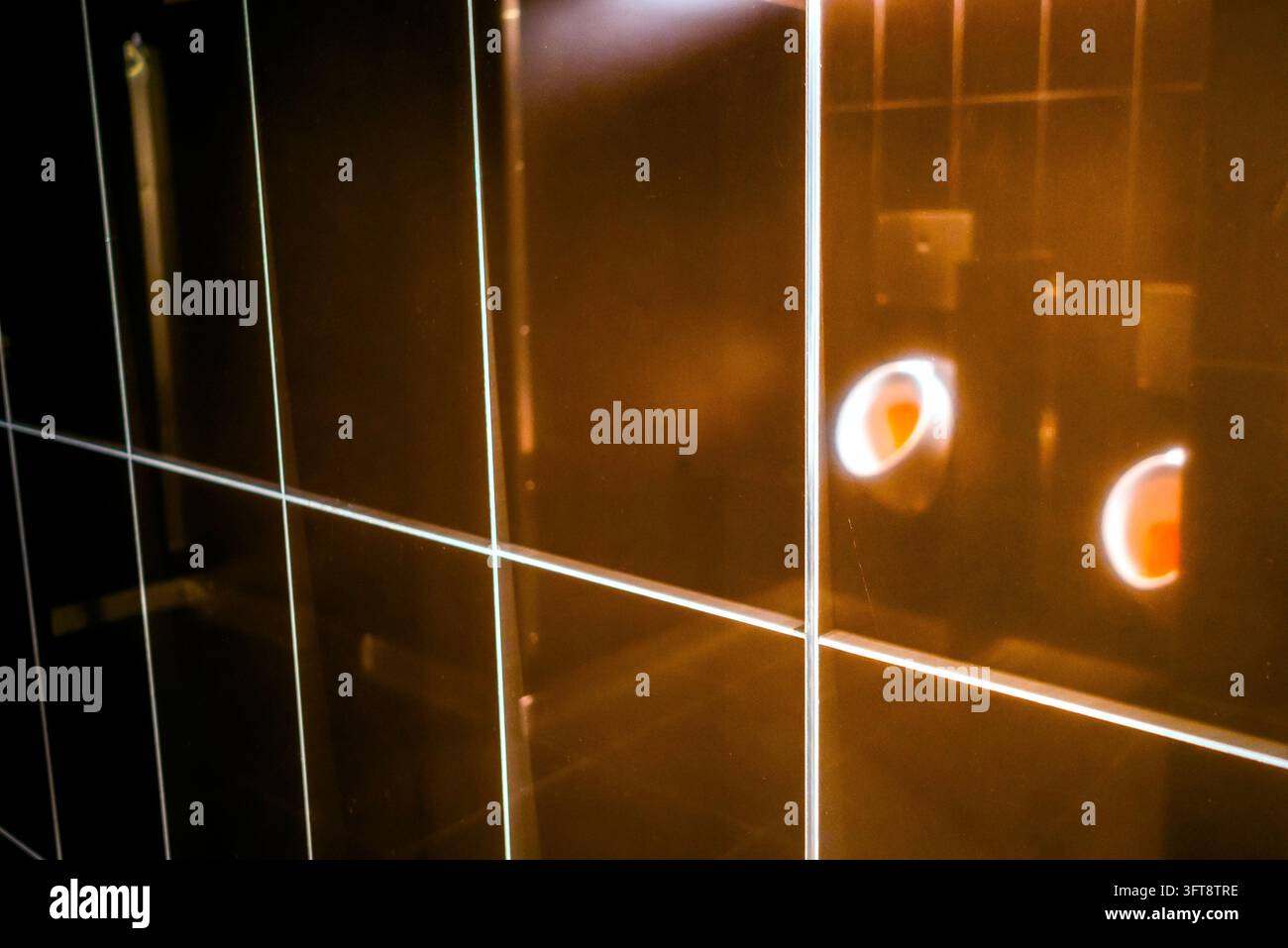 Uninal Urinals in a men’s bathroom in an auction house in New York reflected ...