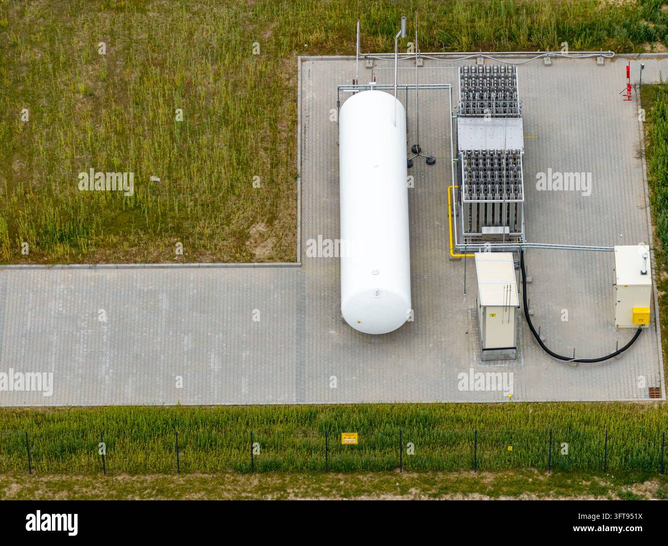 Model Tank Shelf Aerial view of an LNG fueling station featuring a large white storage ...