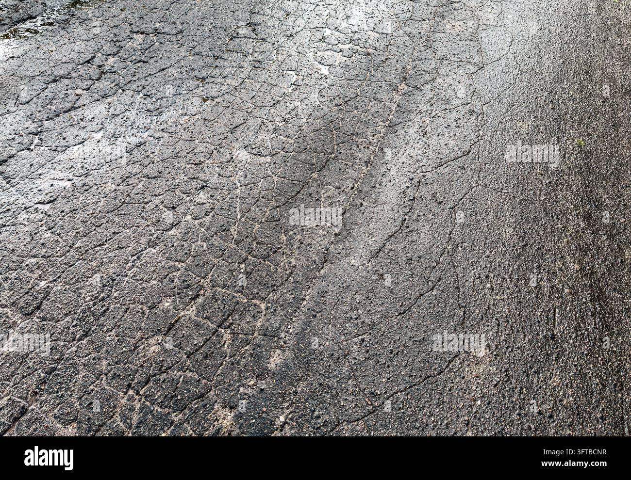 asphalt road after rain. roadway in bad condition with cracks on ...