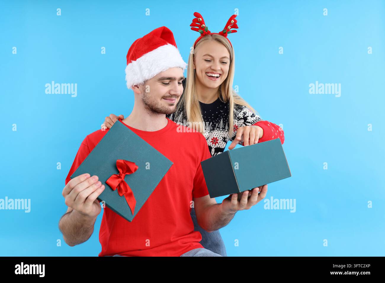 Concept of Christmas gift, young man and woman look in to box Stock ...