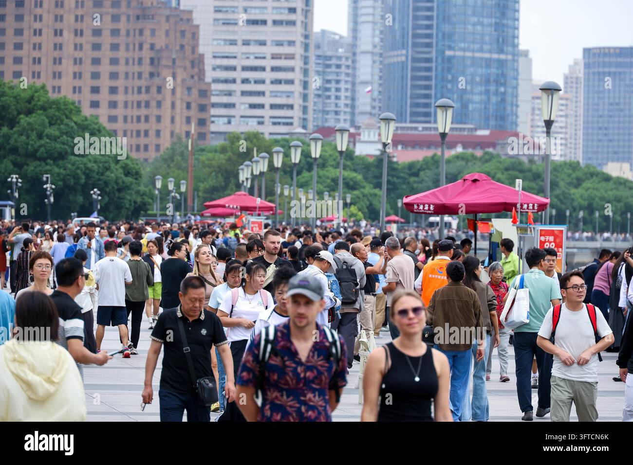 Tourists crowd the observation platform at the Bund in Shanghai on ...