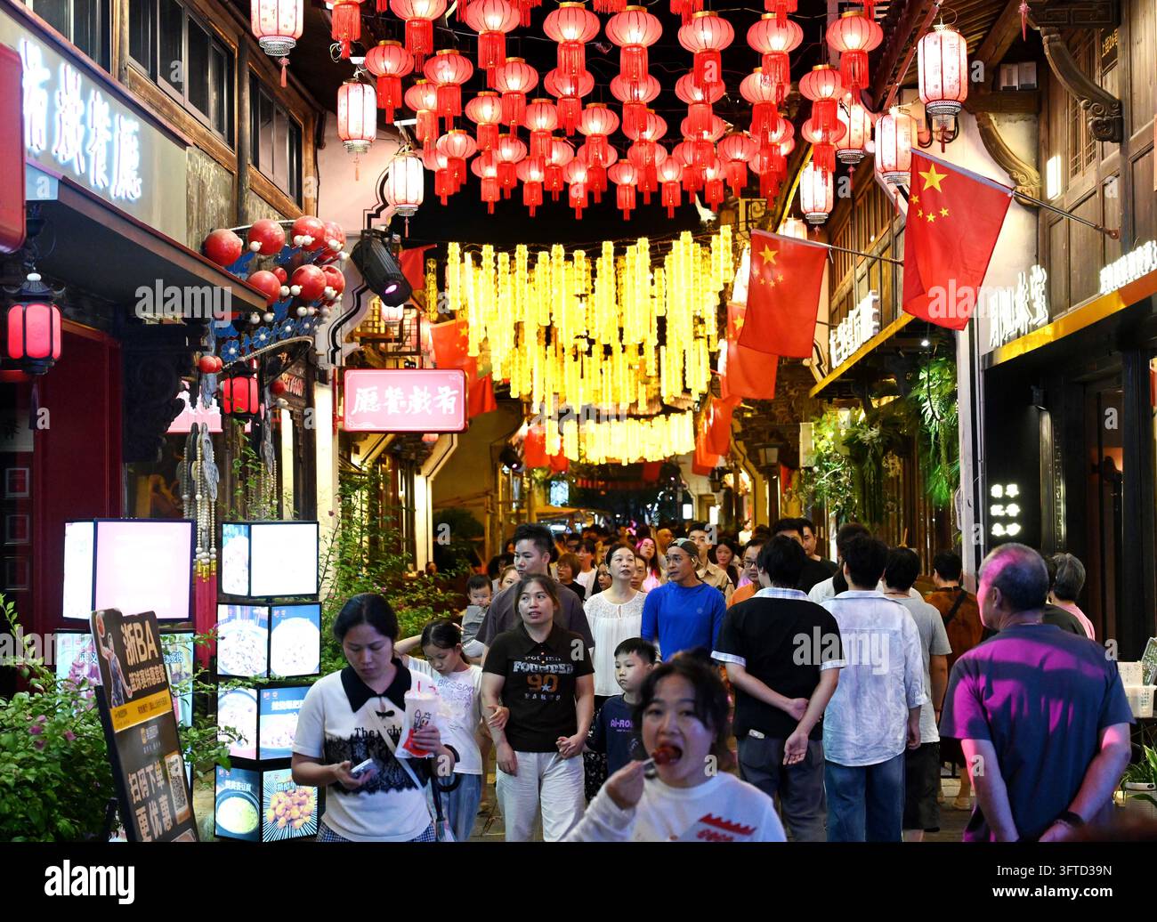 Lanterns twinkle and national flags flutter as crowds throng the ...