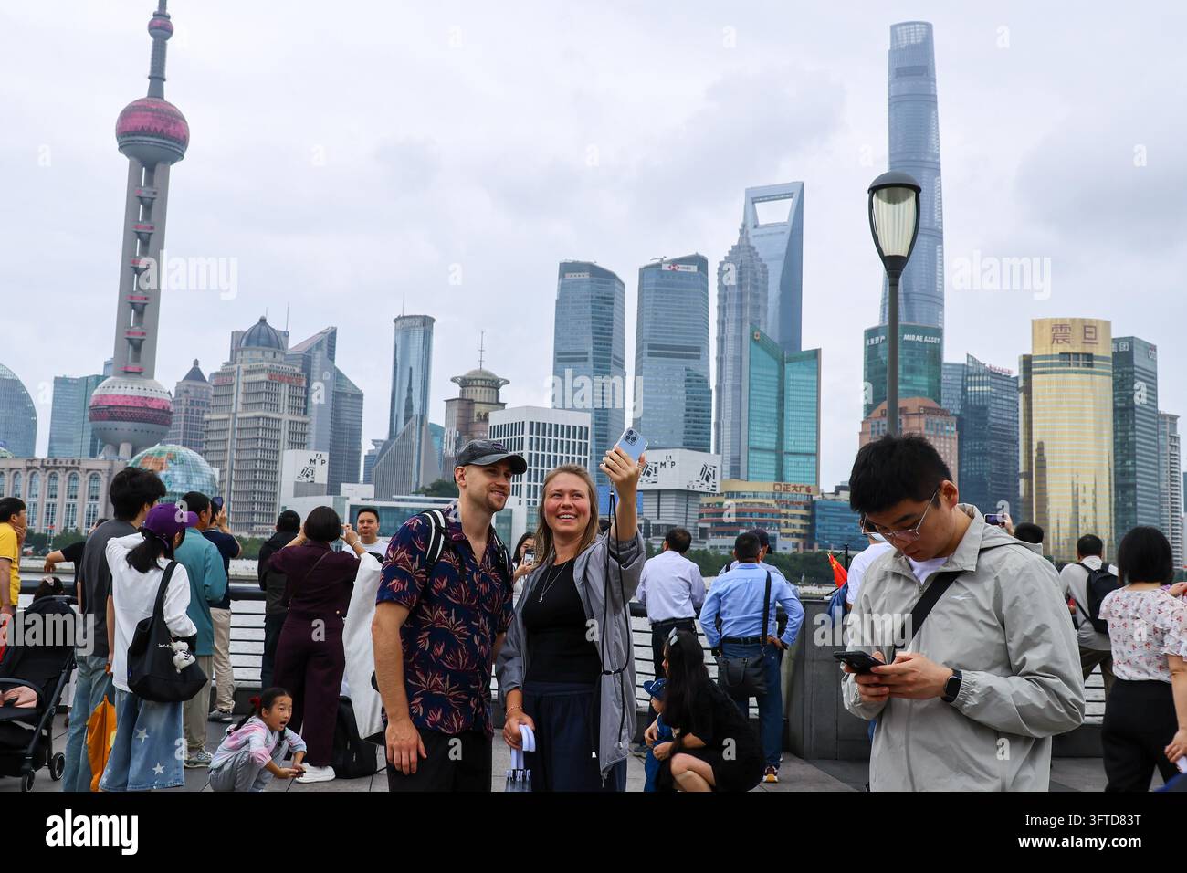 Tourists crowd the observation deck of the Bund in Shanghai on October ...