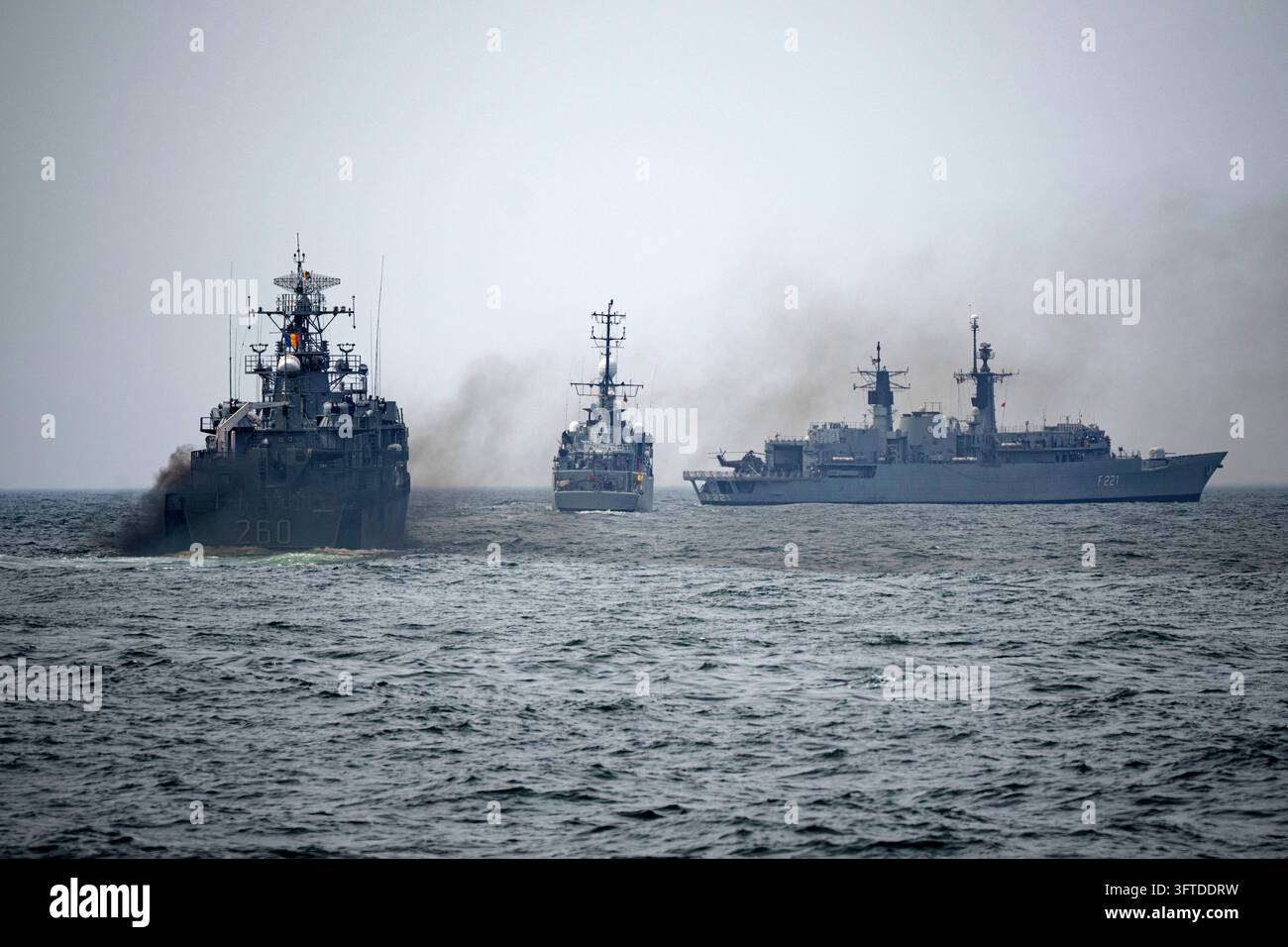 FILE - Romanian warships sail engulfed in smoke during a Romanian Navy ...