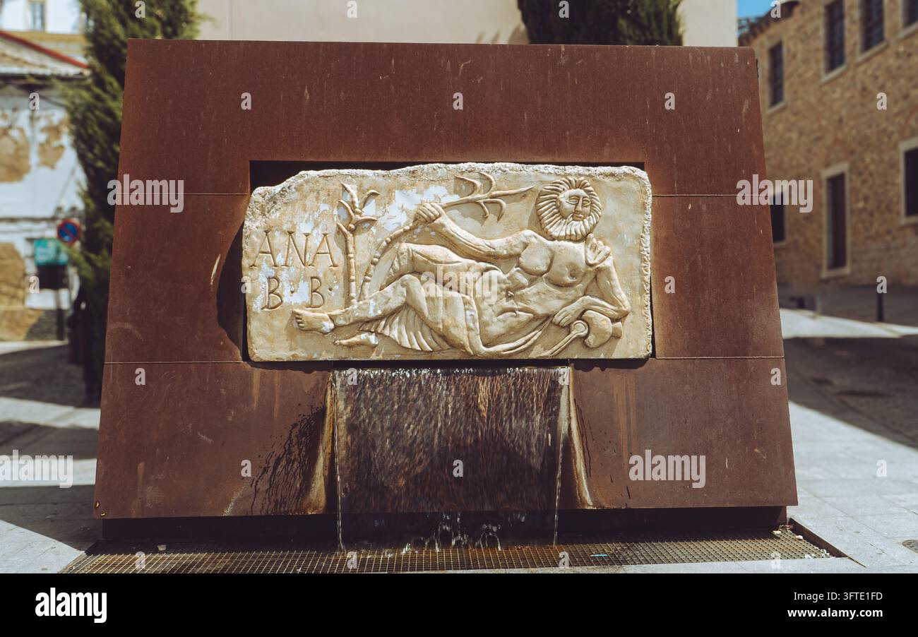 Ancient Roman river god relief sculpture at a modern fountain in Merida ...