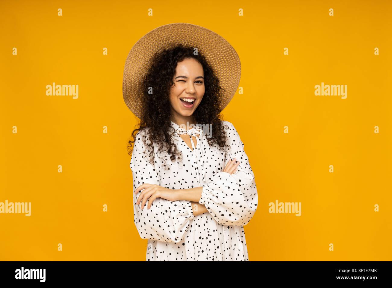 Young woman in dress and hat on yellow background Stock Photo - Alamy
