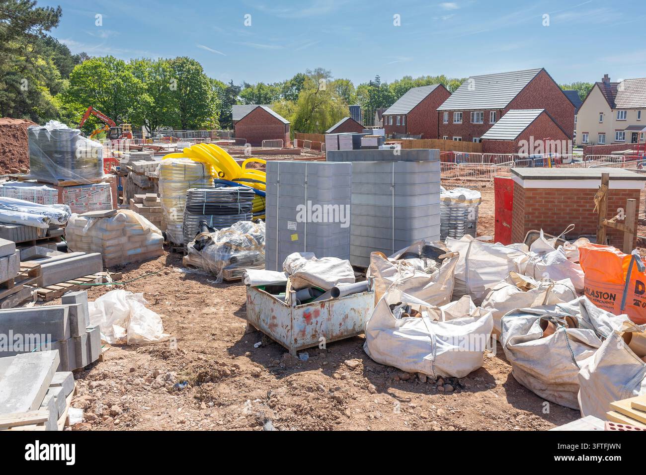 Construction site with finished new build houses in the background and ...