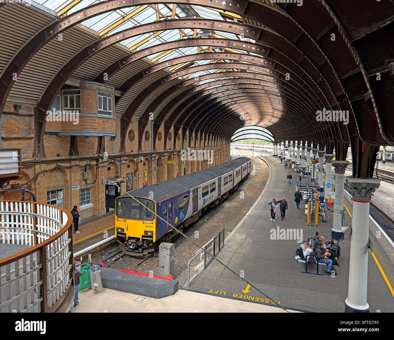 Northern Rail diesel train at York railway station beneath Victorian iron roof Stock Photo