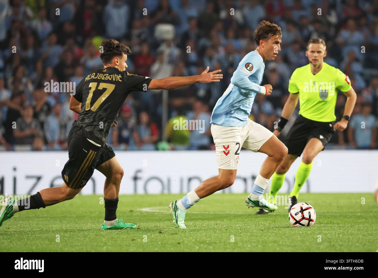 Juventus' Kerim Alajbegovic, left, challenges for the ball with Celta's ...