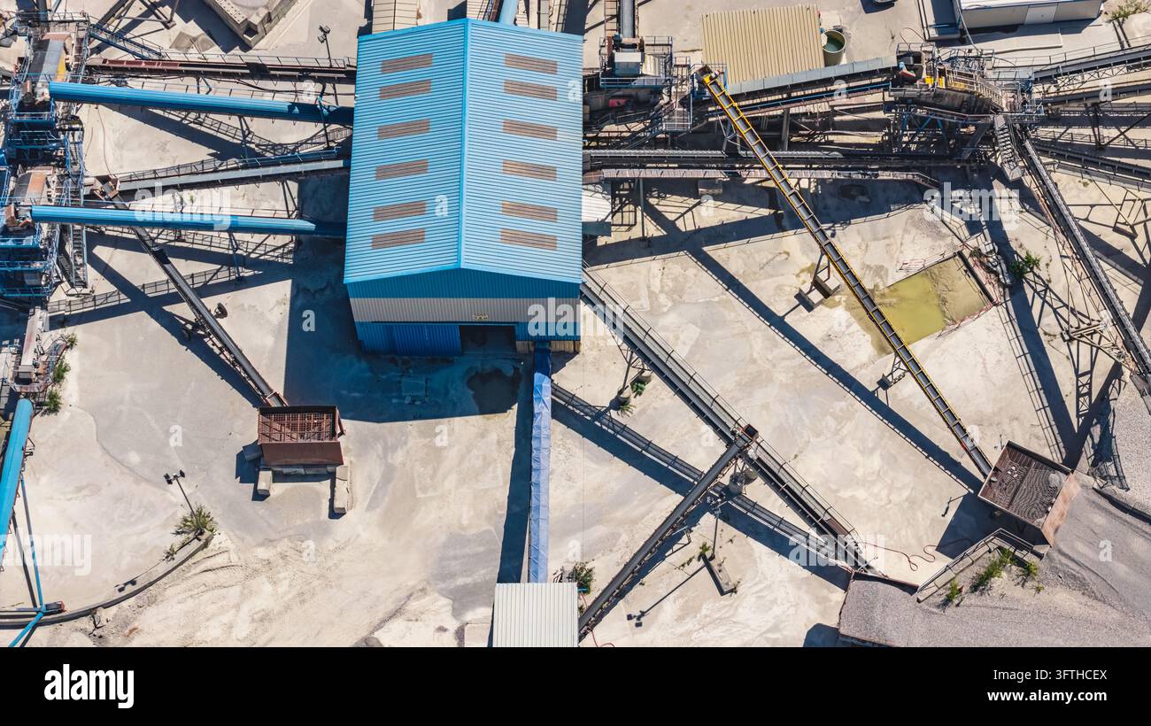 Aggrated Aerial view of an aggregate processing building with a blue roof ...