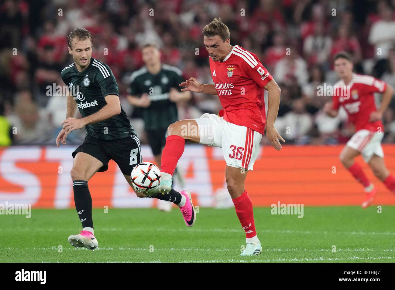 Benfica's Joao Palhinha, right, controls the ball as Celtic's Benjamin ...