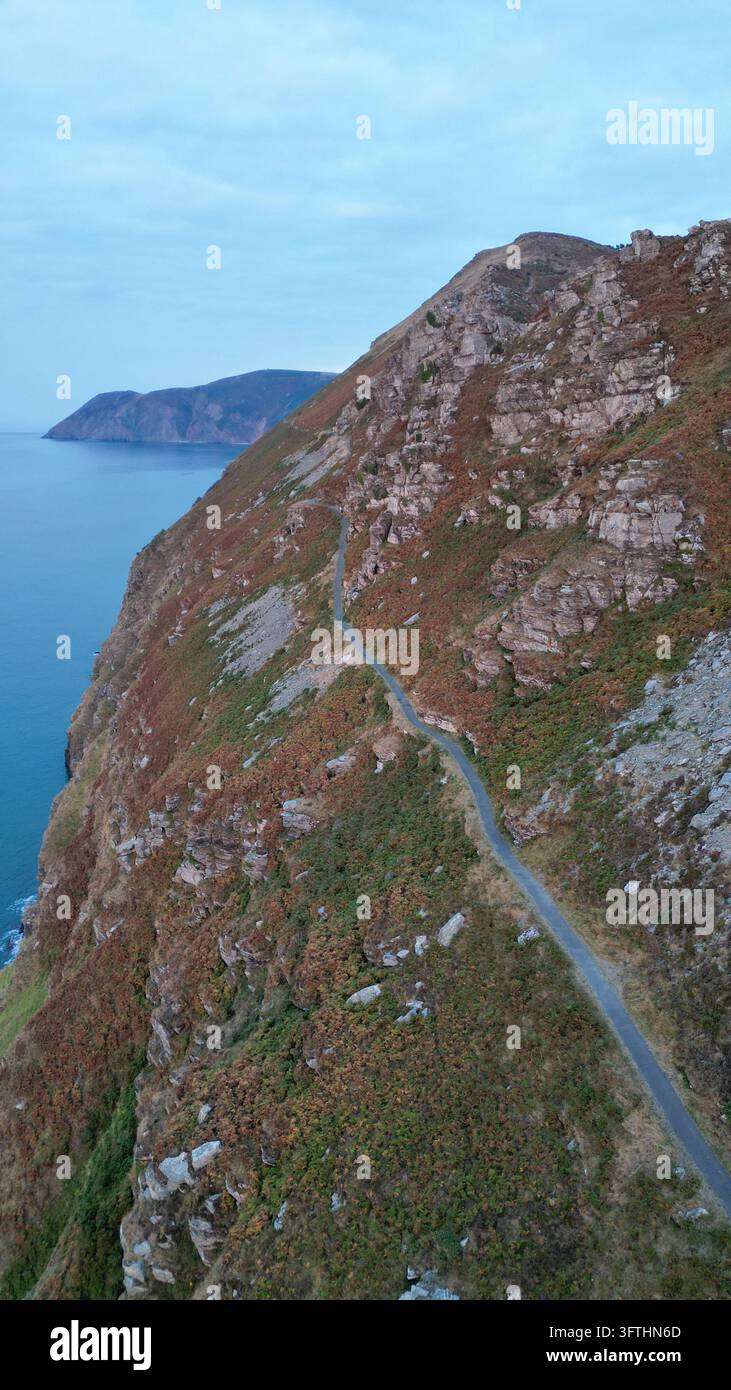 Aerial view of the rugged coastal cliffs and winding road at the Valley ...